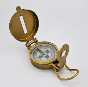 Bussola tipo americano con contenitore dorato, ghiera scorrevole, mirino con lente di ingrandimento, disco magnetico immerso in fluido.